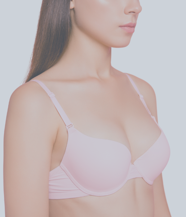 Brüste einer Frau im pinken BH.